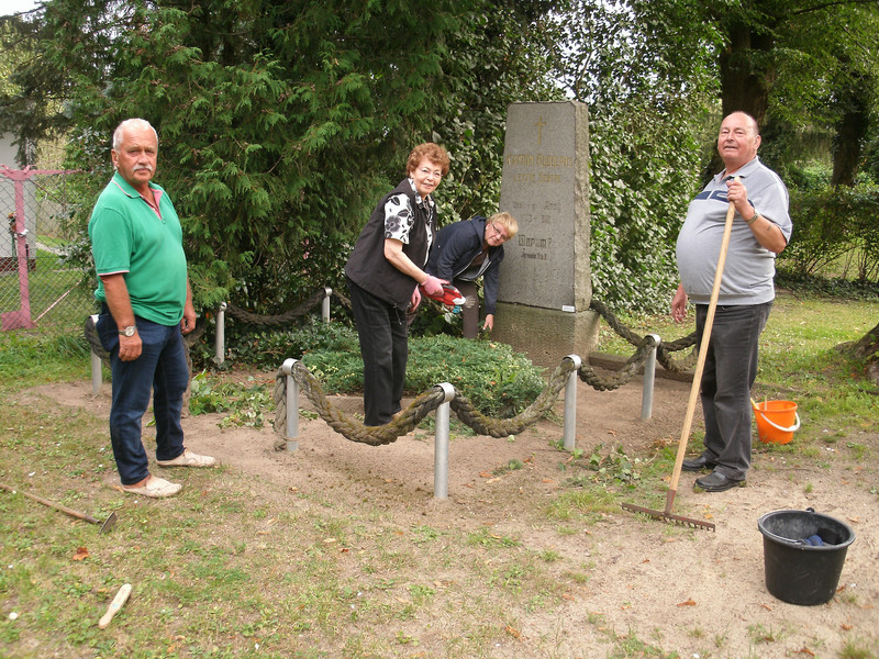 Vier Freiwillige pflegen das Grabmal für gefallene Kameraden der Marinekameradschaft in Tangermünde
